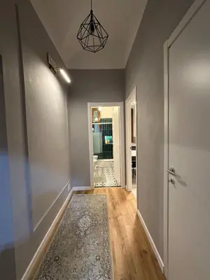 an empty hallway with a door and a rug at Roma center home in Rome