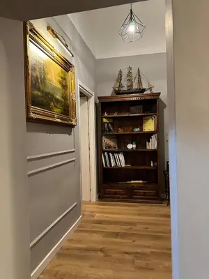 a hallway with a book shelf and a door at Roma center home in Rome