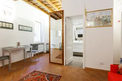 a living room with a table and a mirror at NAVONA, Old Rome Lodge in Rome