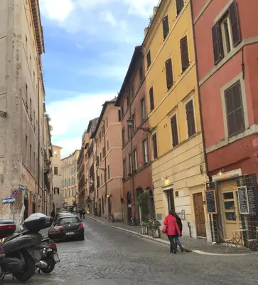 a couple of people walking down a city street at NAVONA, Old Rome Lodge in Rome