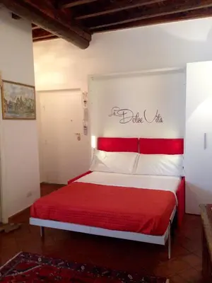 a bedroom with a bed with a red headboard at NAVONA, Old Rome Lodge in Rome