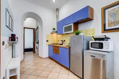 a hallway with a stairway leading to a living room at Coliseum Rome Apartments in Rome