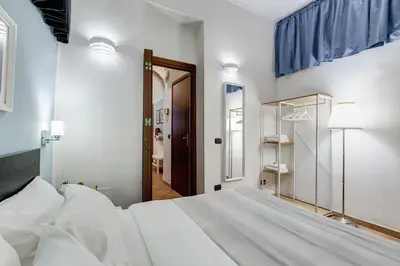a kitchen and dining room with a table and chairs at Coliseum Rome Apartments in Rome