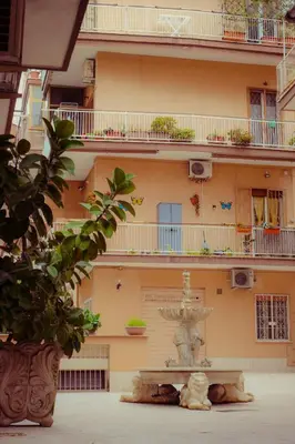 a building with a fountain in front of it at Urban House Monteverde in Rome