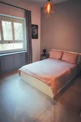 a bedroom with a bed and a window at Urban House Monteverde in Rome
