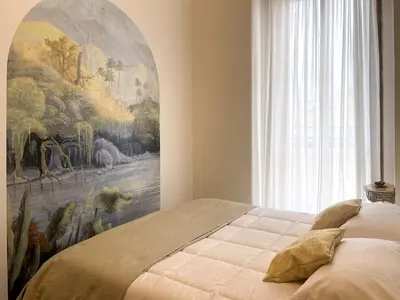 a bedroom with a large painting on the wall at La Casa di Pina in Rome