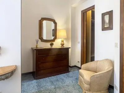 a living room with a dresser and a mirror at La Casa di Pina in Rome