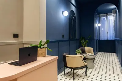 an office with a desk with a laptop and chairs at Saint Suites in Rome