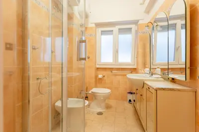 a bathroom with a shower and a toilet and a sink at Casina Soleggiata in Rome