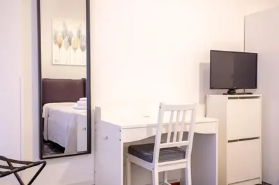 a room with a desk with a tv and a mirror at Casina Soleggiata in Rome