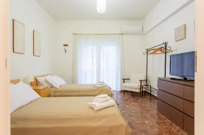 a bedroom with two beds and a flat screen tv at Casina Soleggiata in Rome