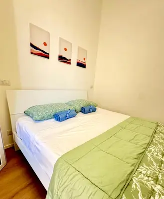 a bedroom with a bed with two blue bags on it at Vaschome in Rome