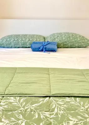 a bed with two blue towels on top of it at Vaschome in Rome