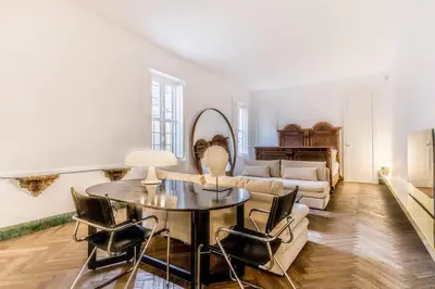 a living room with a table and chairs and a couch at EVA Loft in Rome