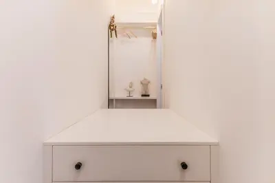 a white dresser with a mirror in a room at EVA Loft in Rome