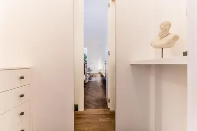 a room with a hallway with white walls and wooden floors at EVA Loft in Rome
