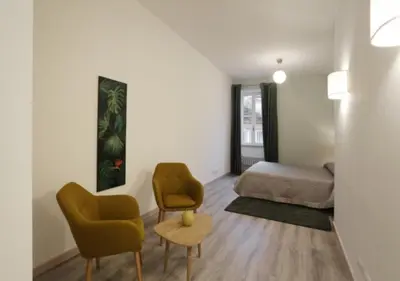 a living room with a bed and two chairs at Centro Roma Verde - LOCAPPART in Rome
