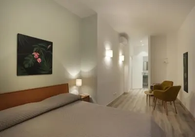 a bedroom with a bed and a living room at Centro Roma Verde - LOCAPPART in Rome