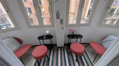 a waiting room with red chairs and windows at Eleganza e stile Capitolino in Rome