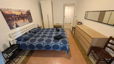 a bedroom with a blue bed in a room at Eleganza e stile Capitolino in Rome