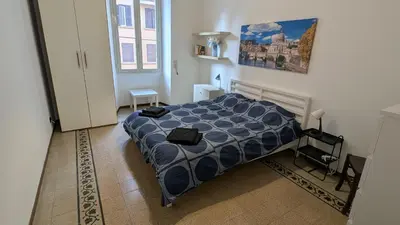 a bedroom with a bed and a painting on the wall at Eleganza e stile Capitolino in Rome