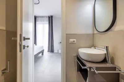 a bathroom with a sink and a mirror at Belli San Giovanni Guest House in Rome