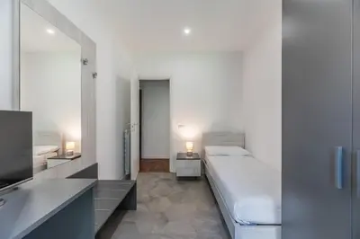 a bedroom with a large bed and a television at Skylife Modern 4-Bedroom Trastevere Apartment in Rome