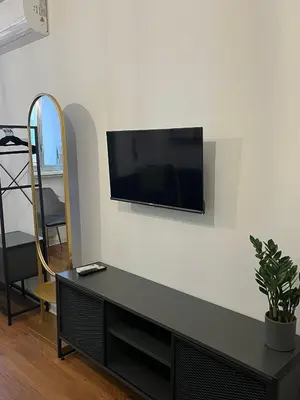a living room with a flat screen tv on a wall at RiversideMellini44 in Rome