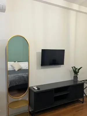 a living room with a mirror and a tv at RiversideMellini44 in Rome