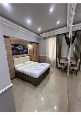 a bedroom with a bed and a desk and a window at Spqr Suite Guest House in Rome