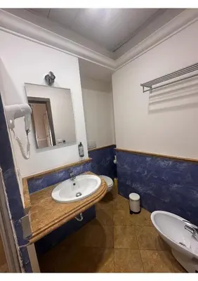 a bedroom with a bed and a painting on the wall at Spqr Suite Guest House in Rome
