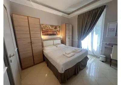 a bedroom with a bed and a painting on the wall at Spqr Suite Guest House in Rome