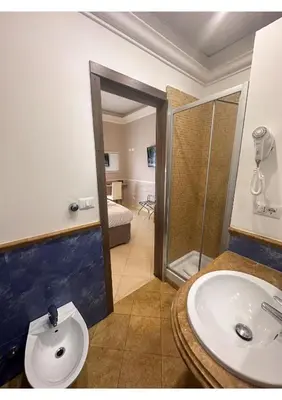 a bedroom with a bed and a table and a desk at Spqr Suite Guest House in Rome