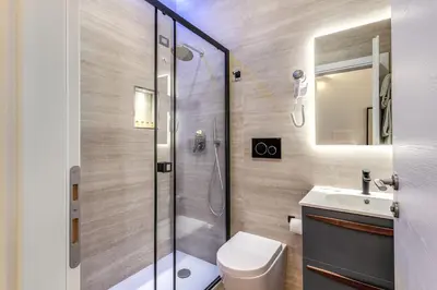 a bathroom with a shower and a toilet and a sink at Rose Inn Guest House in Rome