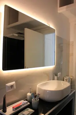 a bathroom with a sink and a large mirror at Alicemaria Vatican Comfortable Apartment in Rome