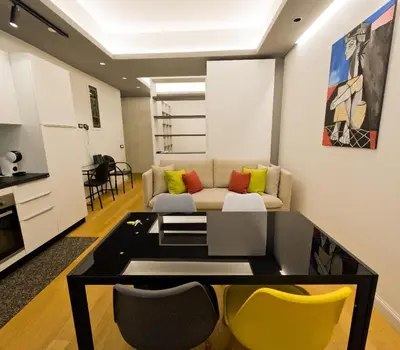 a living room with a couch and some yellow chairs at Appartamento Appia metro A Colli Albani in Rome