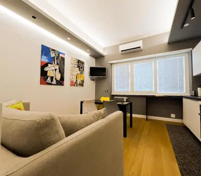 a living room with a couch and a table at Appartamento Appia metro A Colli Albani in Rome