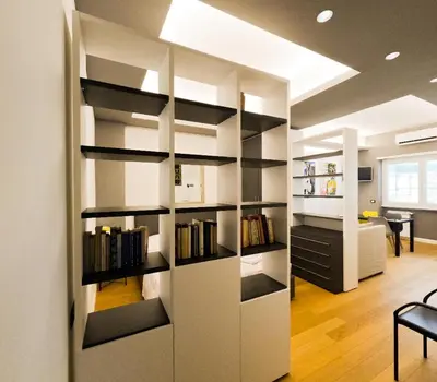 a room with a book shelf with books at Appartamento Appia metro A Colli Albani in Rome