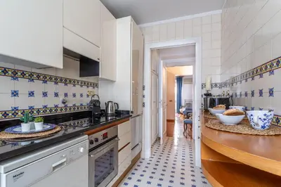 a kitchen with blue and white tiles on the wall at iFlat Classy & Spacious apt near Campo de Fiori in Rome