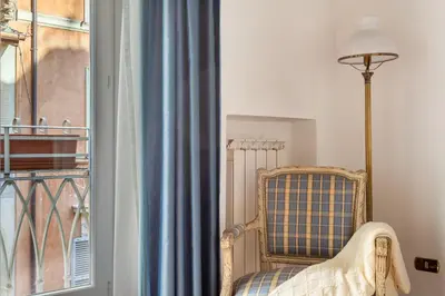 a room with a chair and a window at iFlat Classy & Spacious apt near Campo de Fiori in Rome