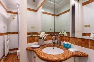 a bathroom with a sink and a mirror at iFlat Classy & Spacious apt near Campo de Fiori in Rome