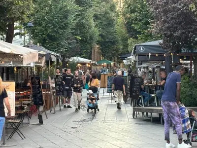 a crowd of people walking through an outdoor market at Roma, Città degli Uomini in Rome