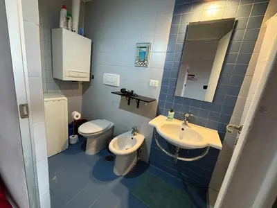a bathroom with a sink and a toilet and a mirror at Roma, Città degli Uomini in Rome