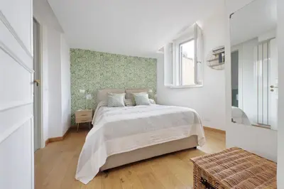 a white bedroom with a large bed and a window at Montevecchio2 in Rome