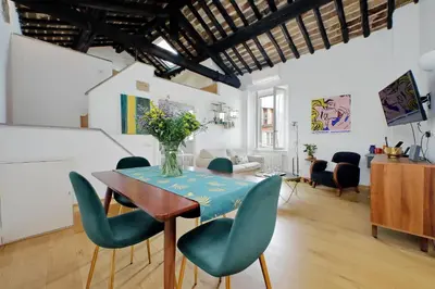 a dining room with a table with green chairs at Montevecchio2 in Rome