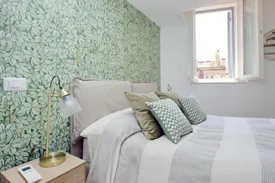 a bedroom with a bed with a green leafy wallpaper at Montevecchio2 in Rome