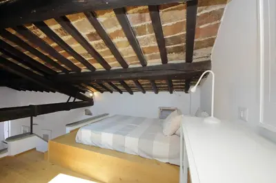 a bedroom with a bed and a wooden ceiling at Montevecchio2 in Rome