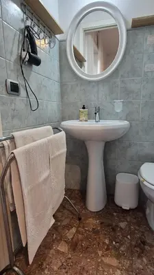 a bathroom with a sink and a mirror at Soggiorni Romani in Rome