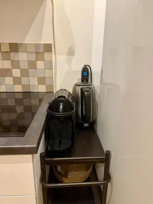 a refrigerator with a tea kettle on a shelf at Monti Cozy Apartment in Rome