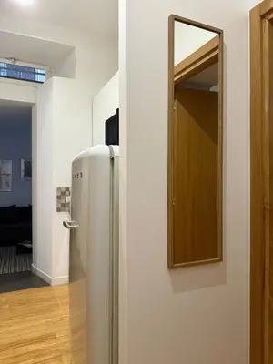 a room with a refrigerator and a mirror on the wall at Monti Cozy Apartment in Rome